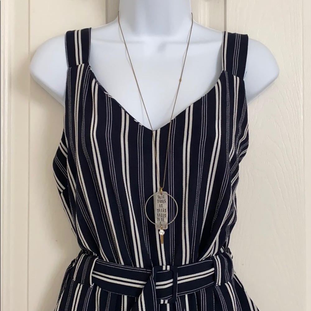 Sleeveless vertical-striped jumpsuit with belt